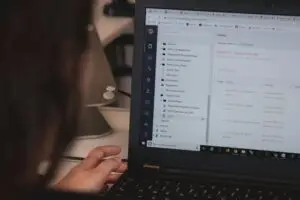 Founder writing at a desk in a small studio — brand voice for small organizations
